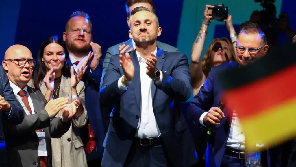 Ulrich Sigmund applauds on stage at an AfD election night party after the polling stations closed in the Saxony-Anhalt state election and exit poll results were announced in Magdeburg, Germany, on 6 September 2026 © Fabrizio Bensch / Reuters